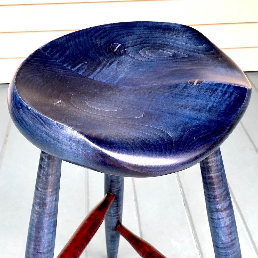 Tripod stool, 22" high for drawing, painting or if you spend long hours at the drafting table, practice your guitar or any other instruments. Blue and red tiger maple wood stool.