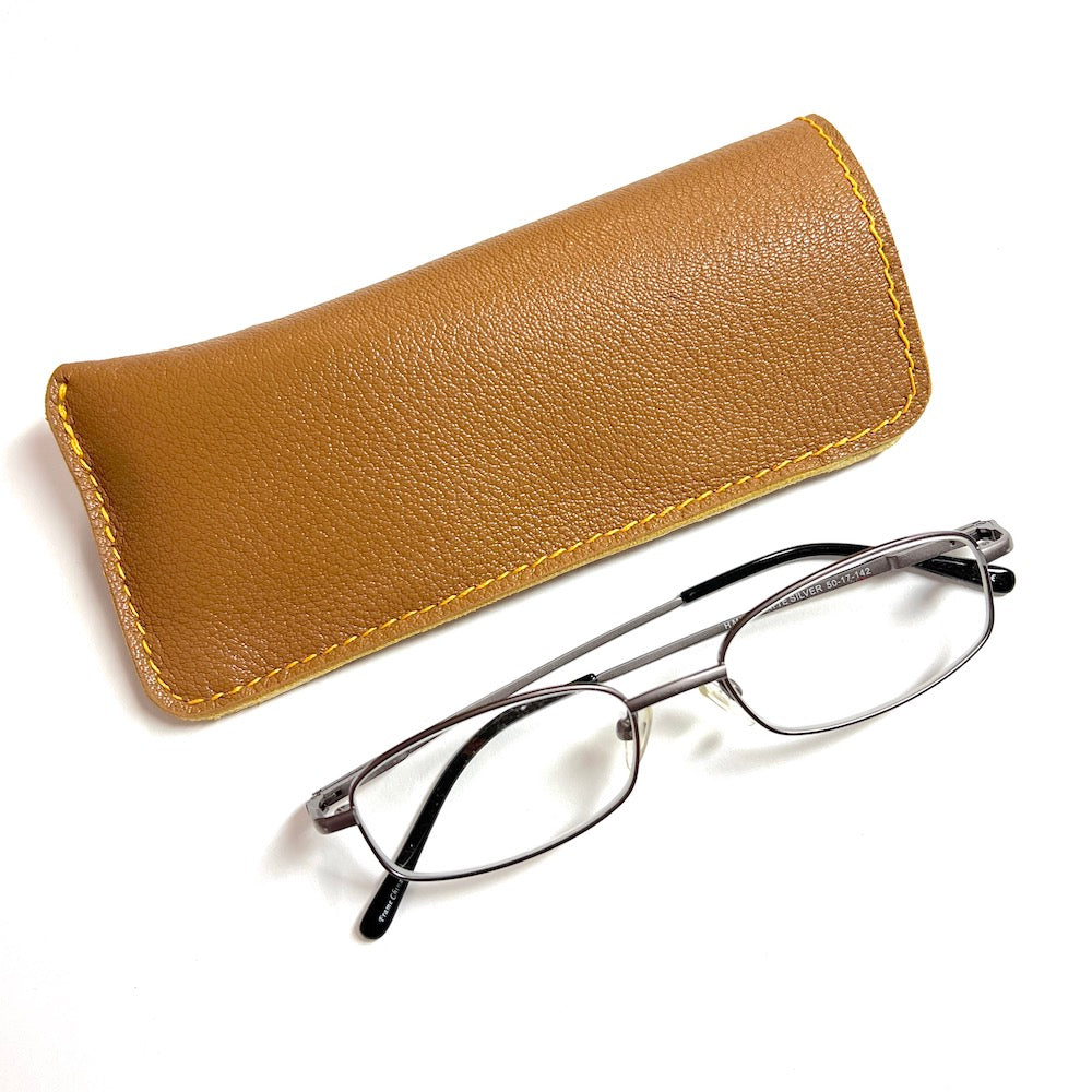 Light brown goatskin leather eyewear case with a deerskin lining next to a pair of medium Rx glasses. Handmade eyewear sleeve, eyewear case.