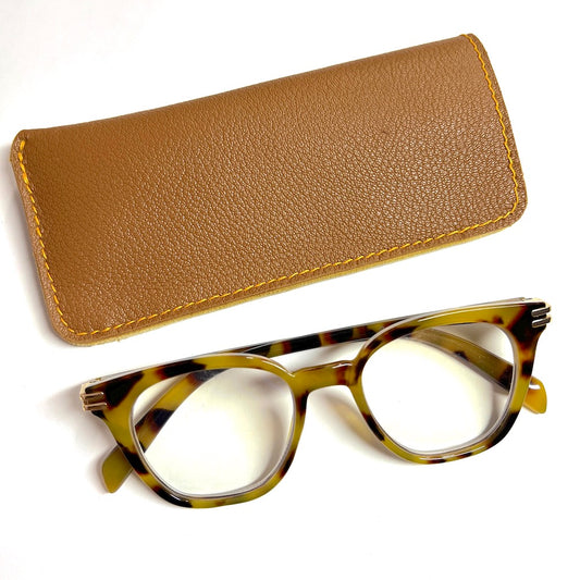 Light brown goatskin leather eyewear case with a deerskin lining next to a pair of medium Rx glasses.