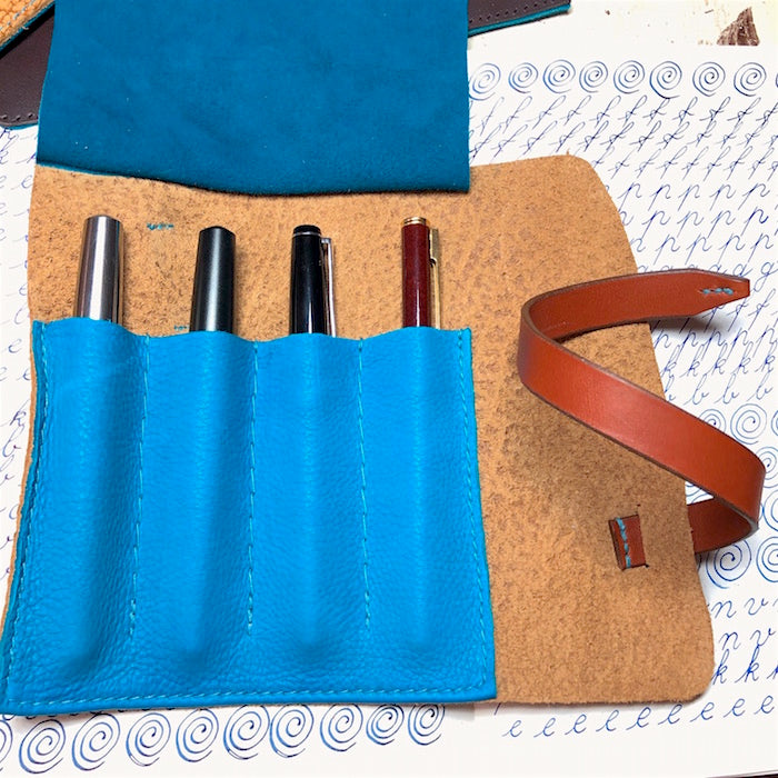 Handmade leather pen holder for 4 pens.