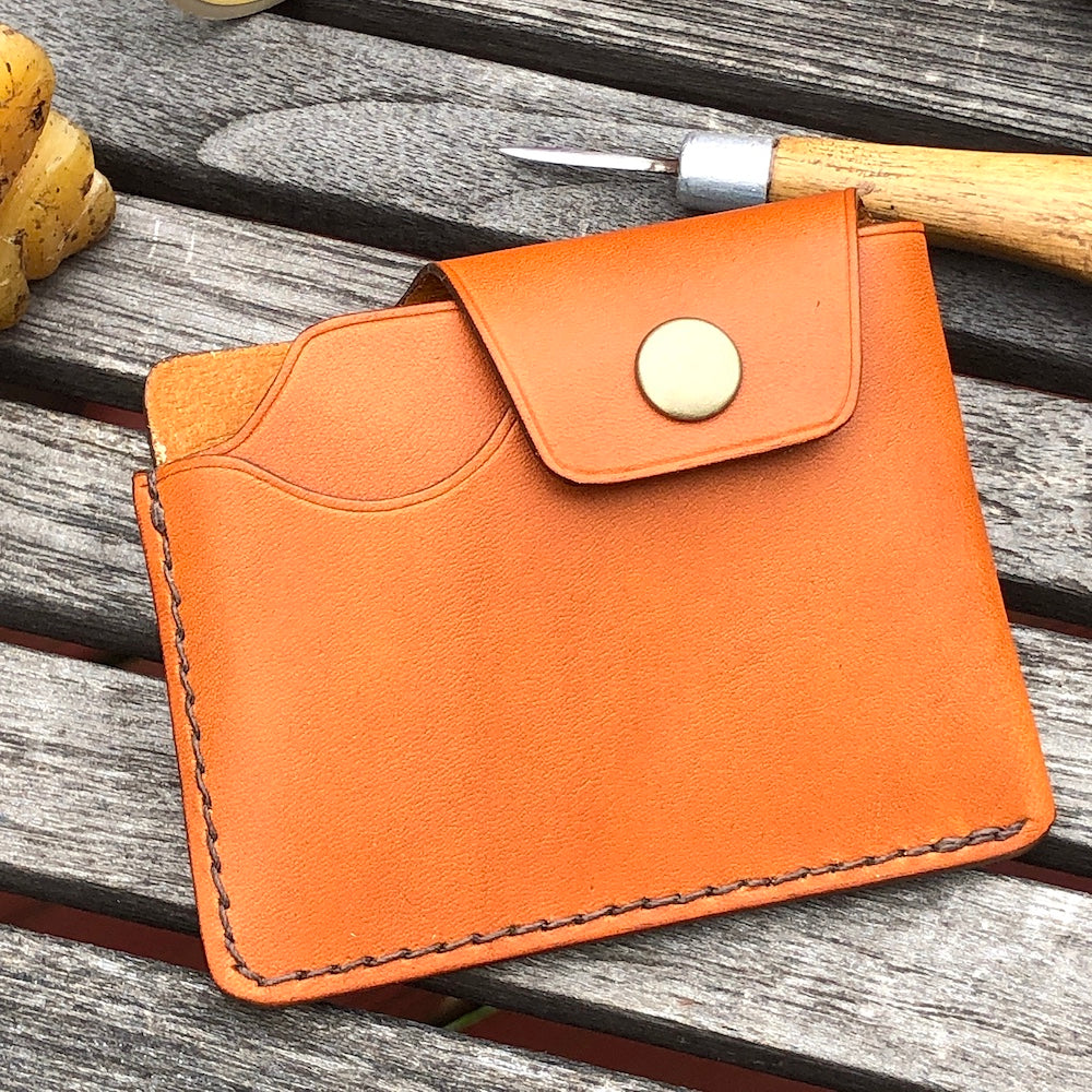 Handcrafted wallet from vegetable dyed cowhide. The edge is coated and polished. Perfect fit for any pocket, front or back, tight or loose, without bulk. It will hold credit cards, drivers license, cash, etc. in 3 compartments.