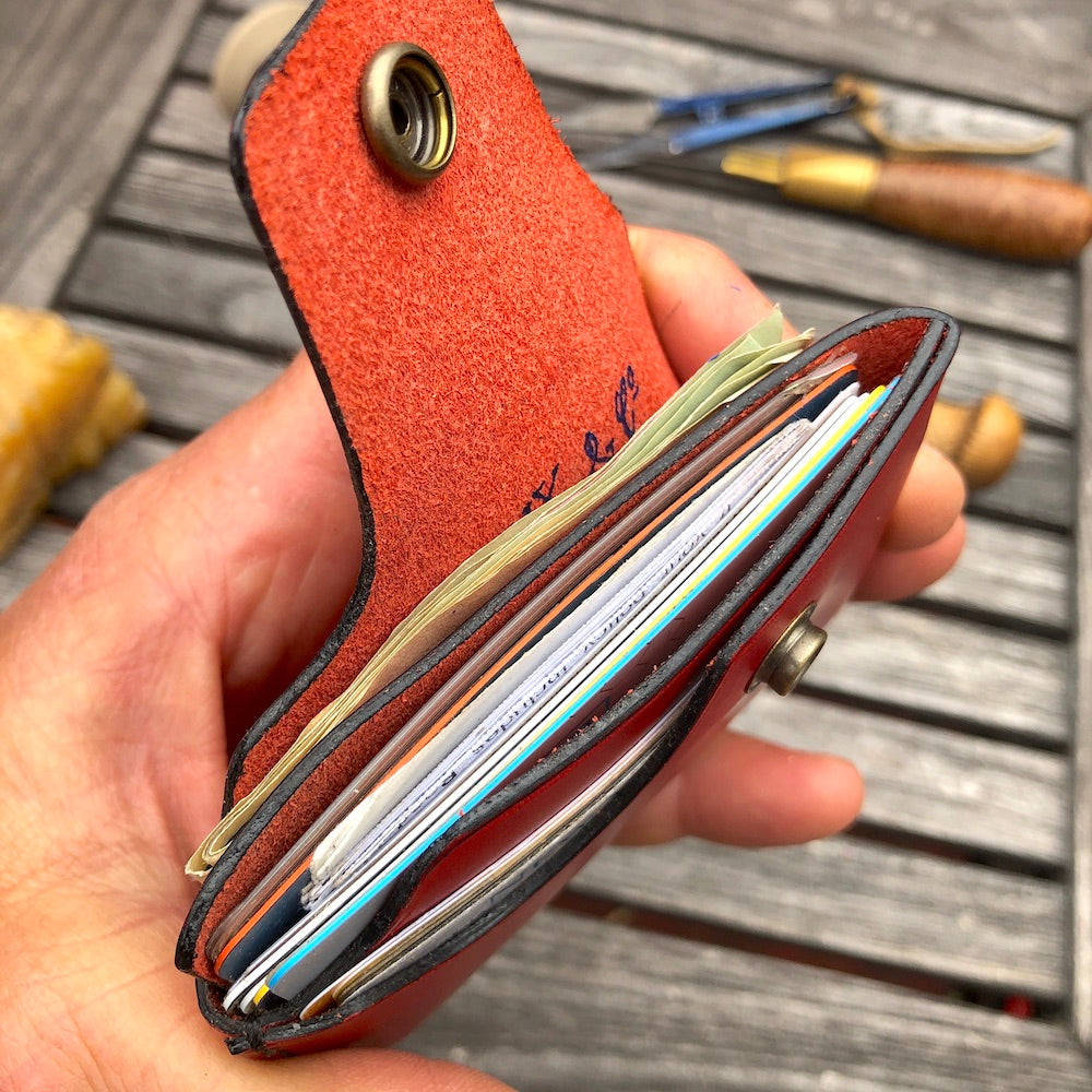 Handcrafted wallet from vegetable dyed cowhide. The edge is coated and polished. Perfect fit for any pocket, front or back, tight or loose, without bulk. It will hold credit cards, drivers license, cash, etc. in 3 compartments.