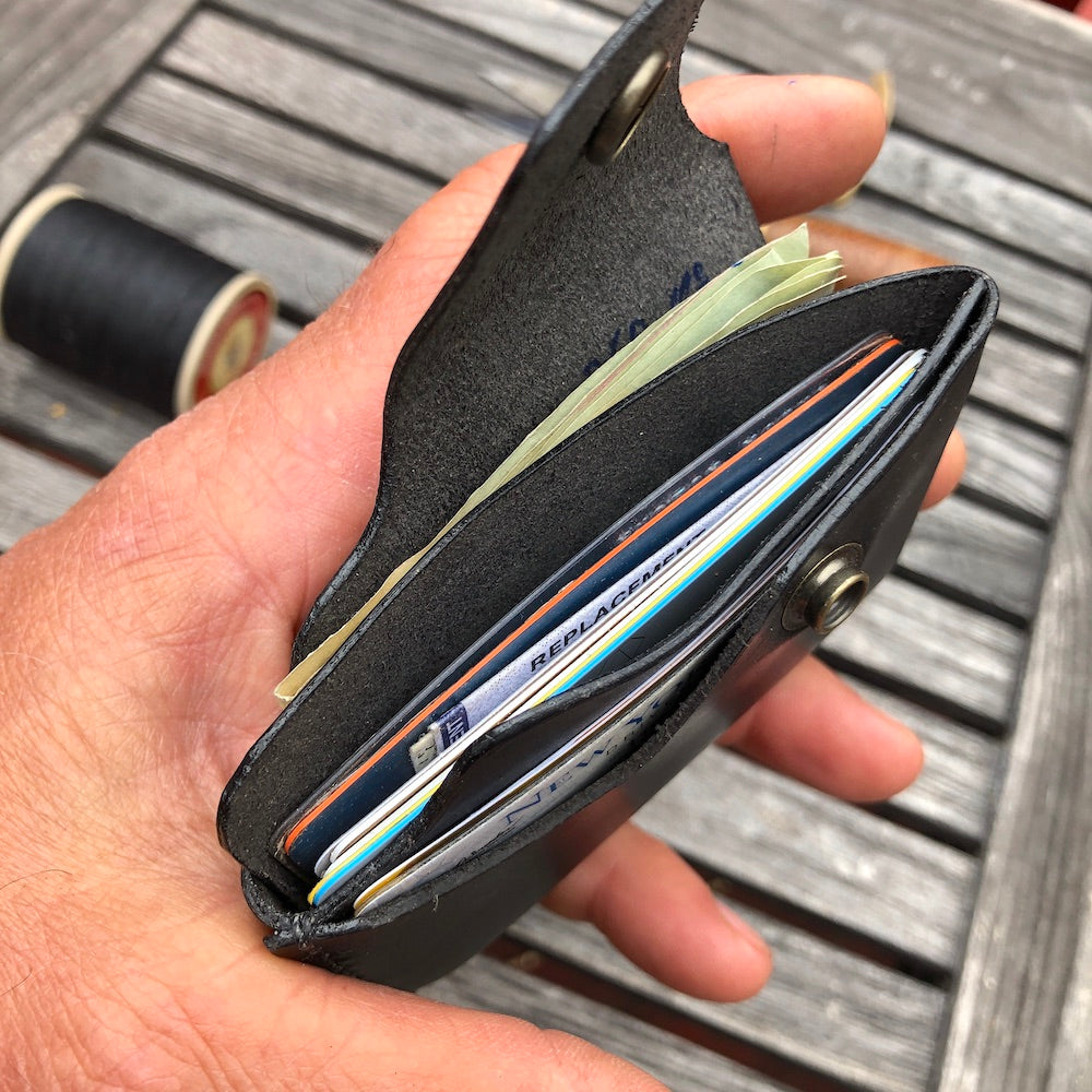 Handcrafted wallet from vegetable dyed cowhide. The edge is coated and polished. Perfect fit for any pocket, front or back, tight or loose, without bulk. It will hold credit cards, drivers license, cash, etc. in 3 compartments.