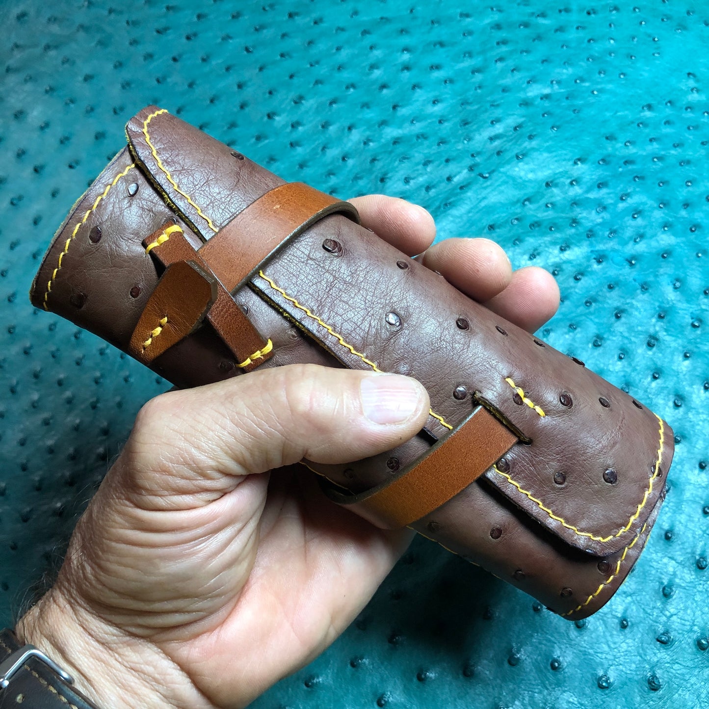 Brown ostrich pen roll, fountain pen case with brown leather closure.