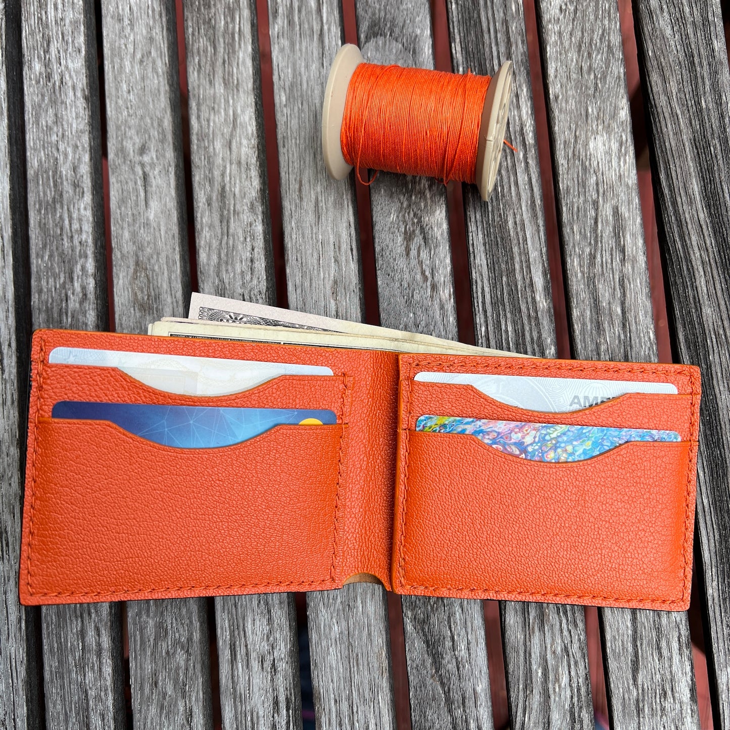 Black Cordovan, Orange goat skin  leather wallet with card slots and money pocket. 
