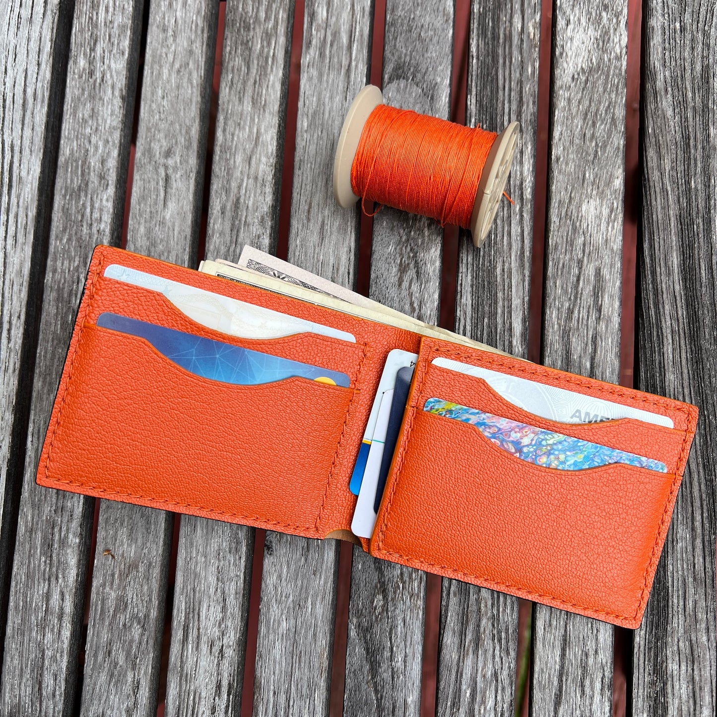 Black Cordovan, Orange goat skin  leather wallet with card slots and money pocket. 