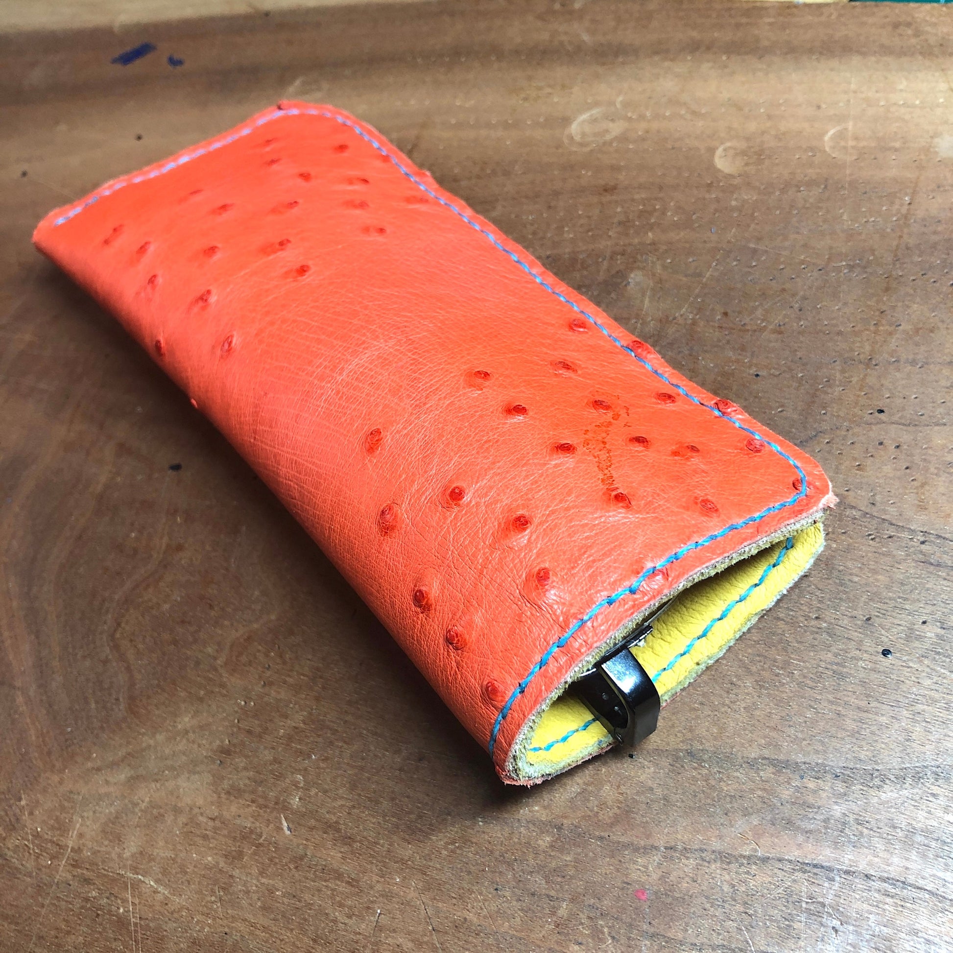 Ostrich leather eyewear case, eyewear sleeve. Paprika red with golden yellow deerskin lining, turquoise stitching.