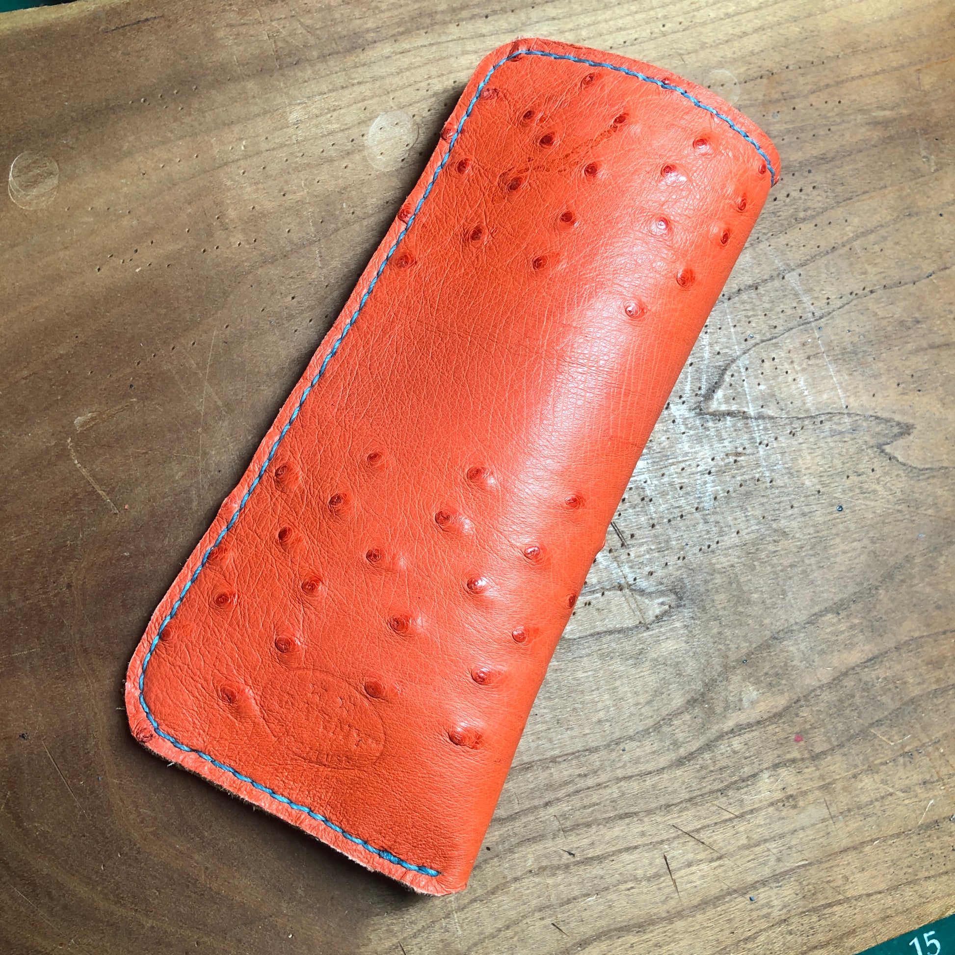 Ostrich leather eyewear case, eyewear sleeve. Paprika red with golden yellow deerskin lining, turquoise stitching.