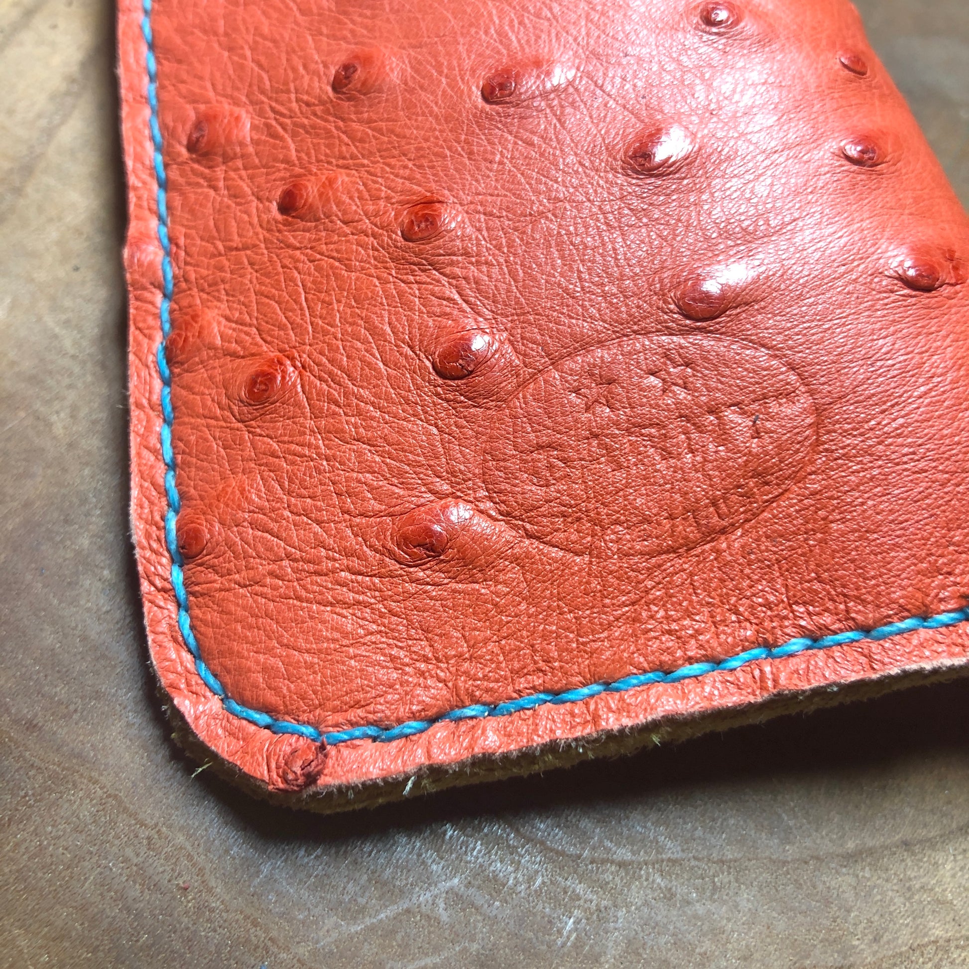 Ostrich leather eyewear case, eyewear sleeve. Paprika red with golden yellow deerskin lining, turquoise stitching.