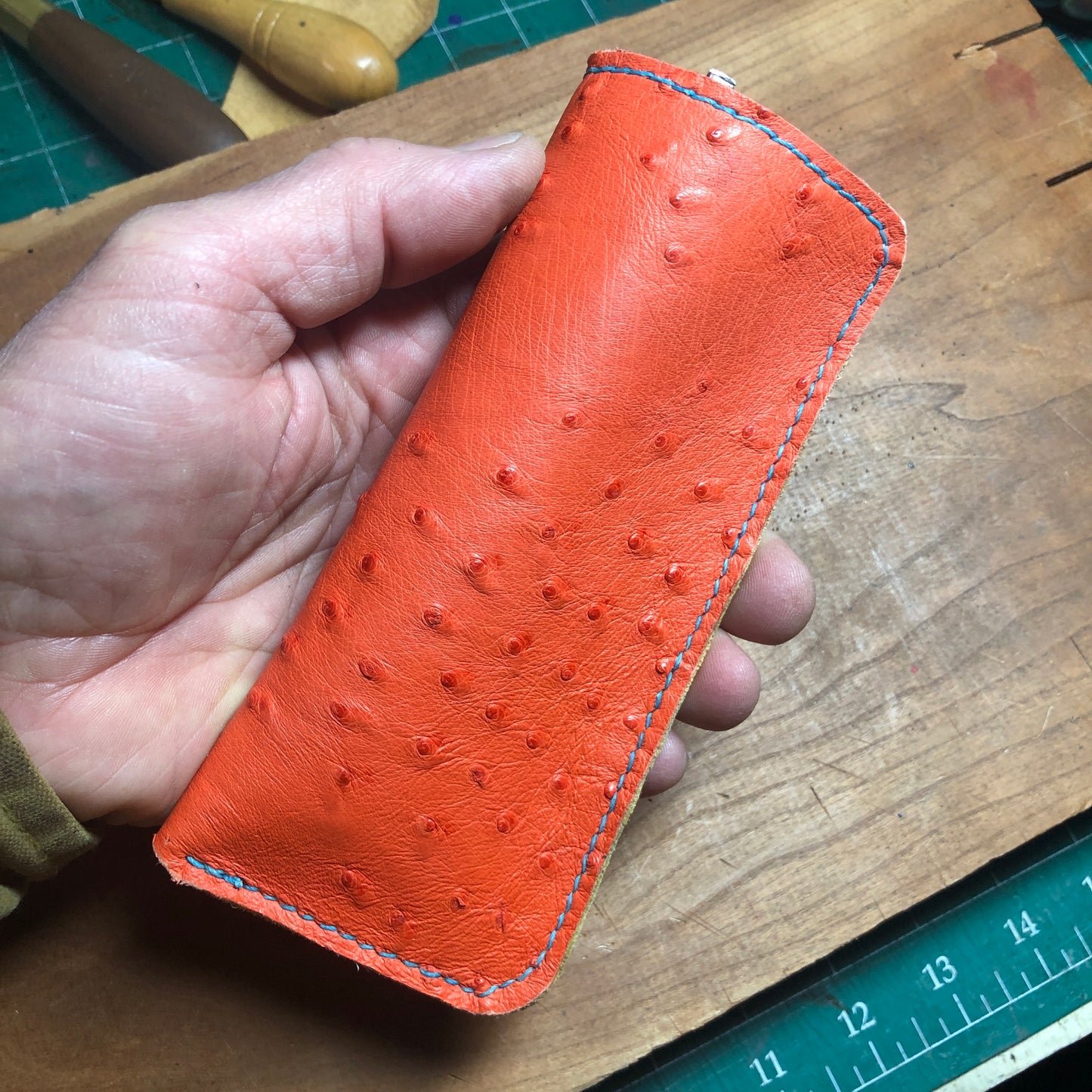Ostrich leather eyewear case, eyewear sleeve. Paprika red with golden yellow deerskin lining, turquoise stitching.