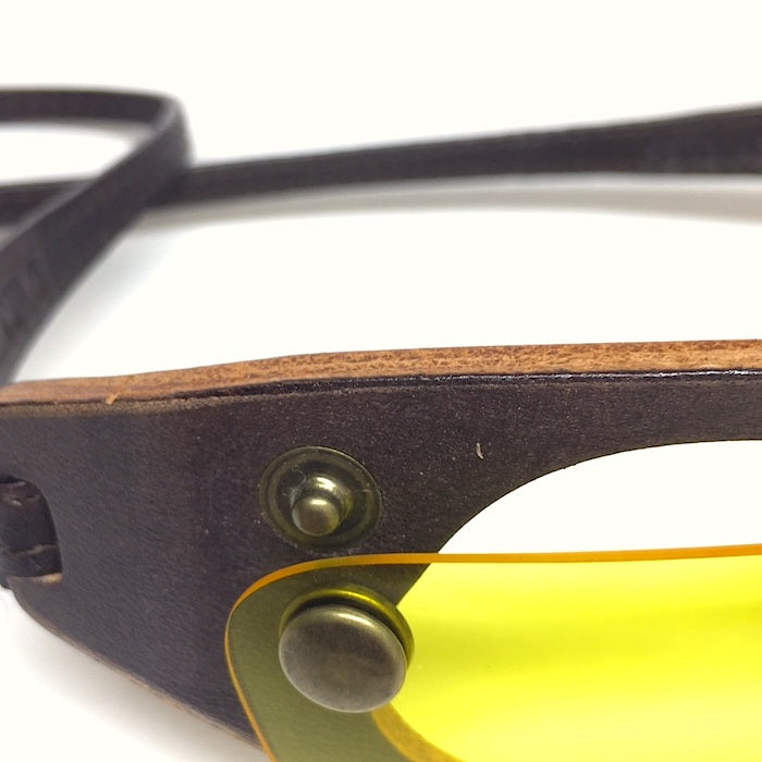 Brown leather sunglasses with removable yellow lenses.