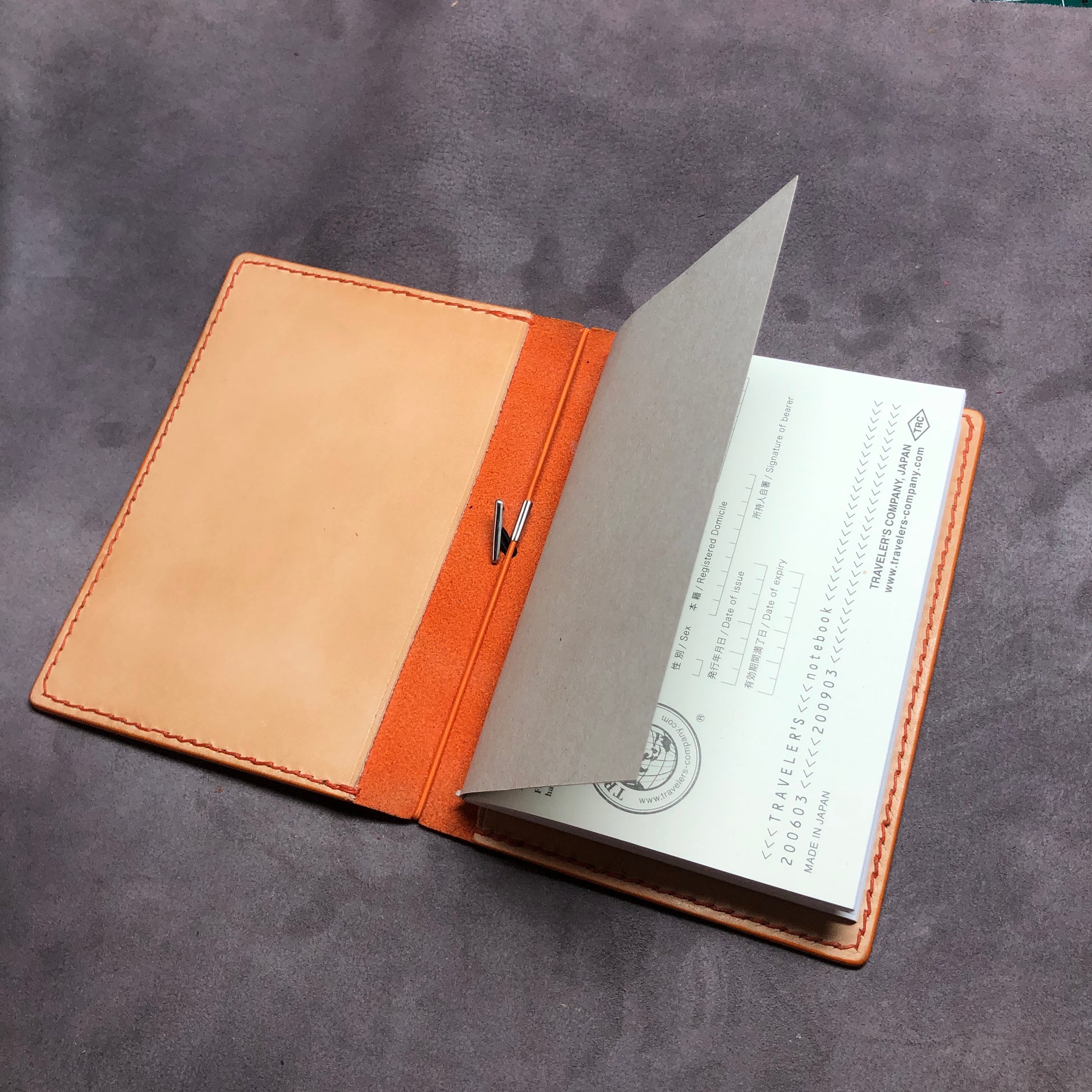 Cowhide leather Passport size Travelers Journal cover.  Hand stitched, finished edges. One Midori Travelers Notebook Journal included.  Orange leather notebook cover. 